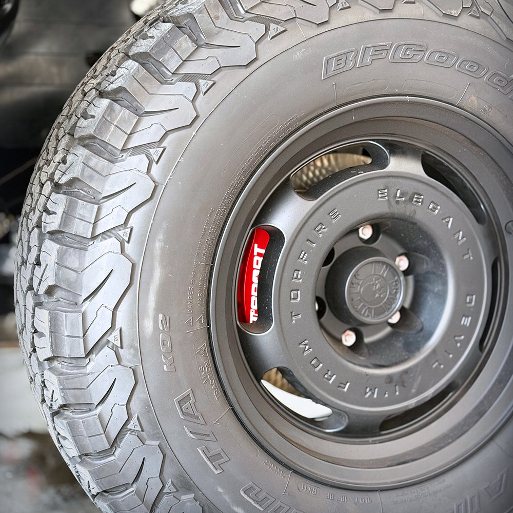 A red TTSPORT 7640TK 6-piston big brake kit is installed on the GWM Tank 500 front wheel.