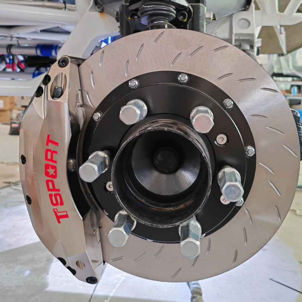 A chrome TTSPORT PB6 6-piston watercooling brake kit installed on a rally racing truck.