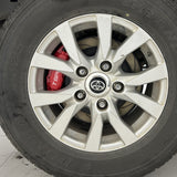 A red TTSPORT Toyota Land Cruiser 200 4-piston big brake kit is installed on the rear wheel.
